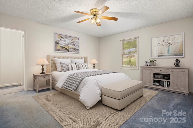 bedroom featuring a textured ceiling, carpet flooring, baseboards, and ceiling fan