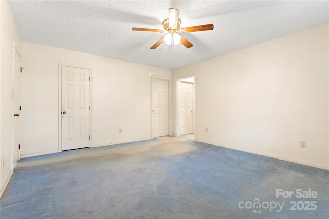 unfurnished room featuring a textured ceiling, a ceiling fan, and light colored carpet