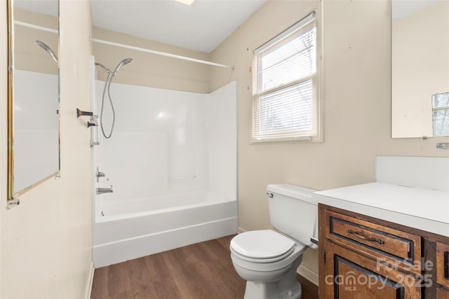 full bath featuring toilet, baseboards, shower / washtub combination, wood finished floors, and vanity