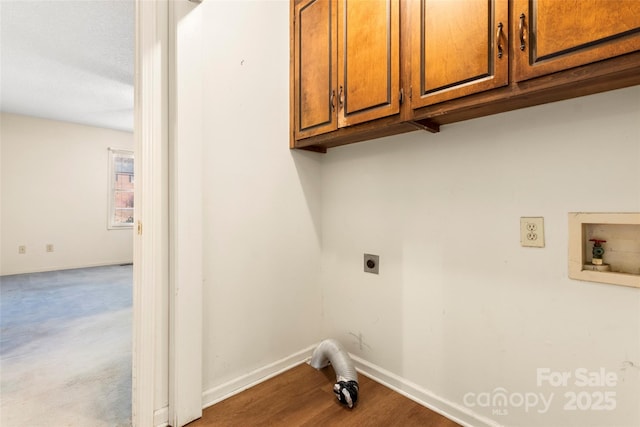 washroom with hookup for an electric dryer, baseboards, washer hookup, wood finished floors, and cabinet space