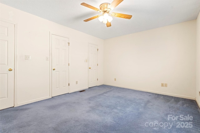 unfurnished bedroom with baseboards, a ceiling fan, and carpet flooring