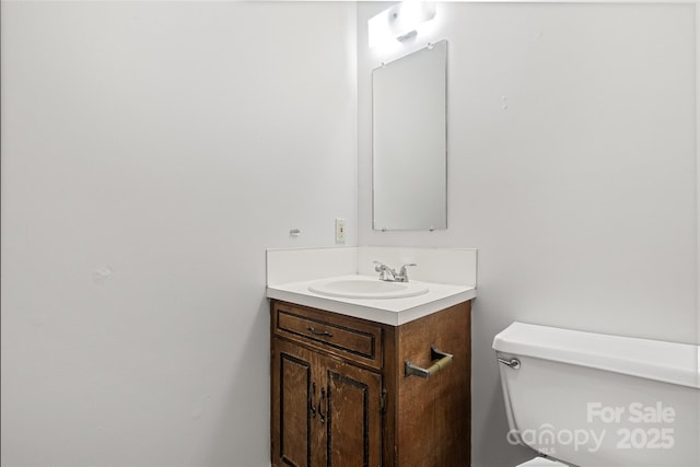 half bath featuring toilet and vanity