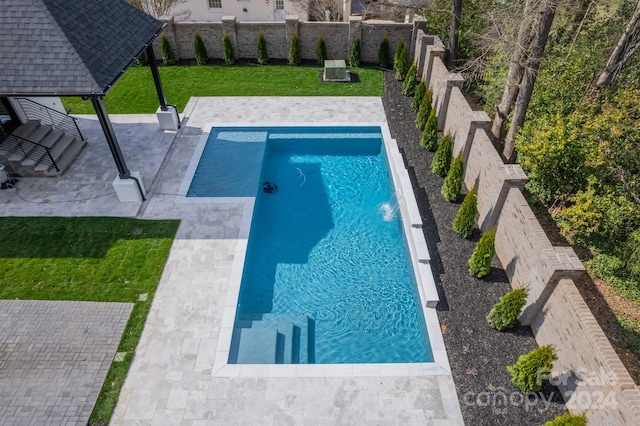 view of swimming pool featuring a gazebo, a lawn, and a patio