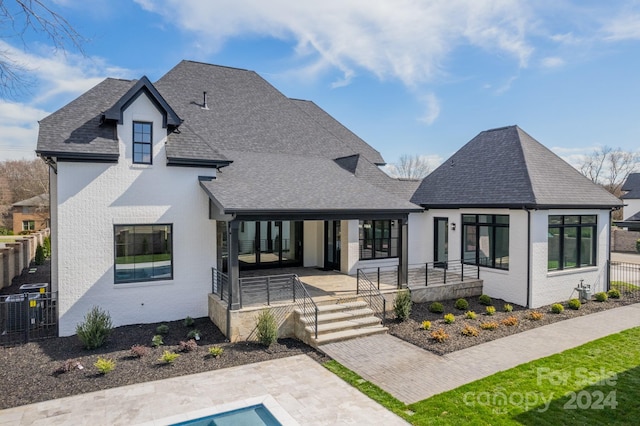 back of property with covered porch