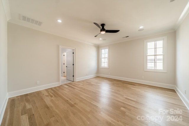 empty room featuring ceiling fan, crown molding, and light hardwood / wood-style floors