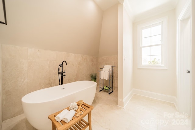 bathroom featuring tile walls and a bathtub