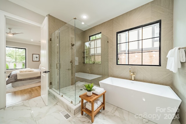 bathroom featuring plus walk in shower, ornamental molding, and tile walls