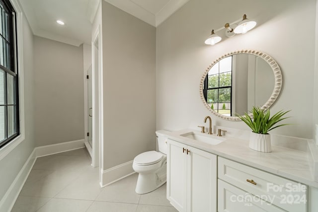 bathroom featuring toilet, tile patterned flooring, crown molding, and vanity