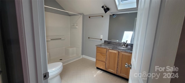 bathroom featuring walk in shower, toilet, vanity, a skylight, and tile floors