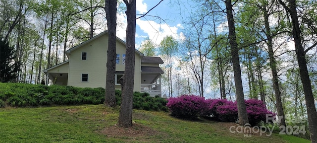 view of property exterior featuring a lawn