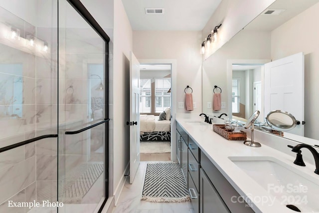 bathroom featuring a shower with shower door, oversized vanity, and double sink