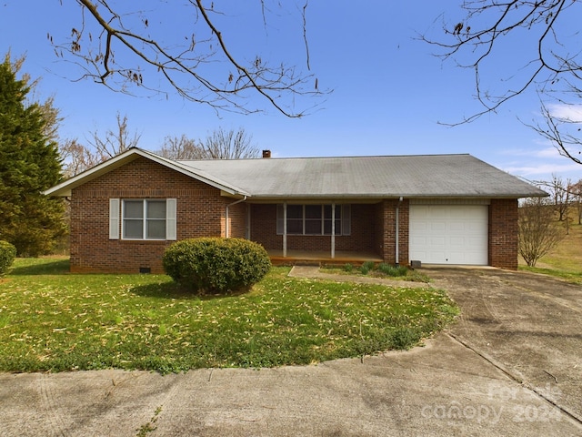 ranch-style home featuring a front lawn and a garage