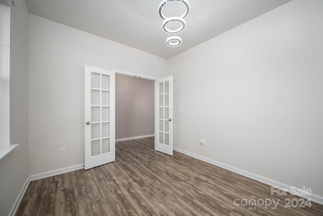 empty room featuring dark hardwood / wood-style floors and french doors