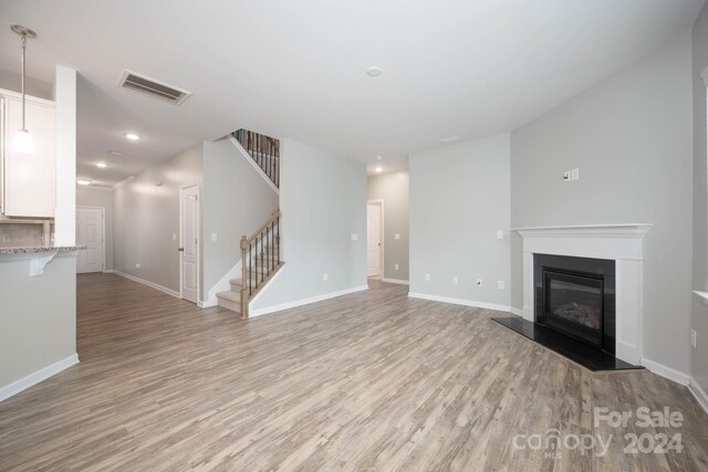 unfurnished living room featuring light hardwood / wood-style flooring