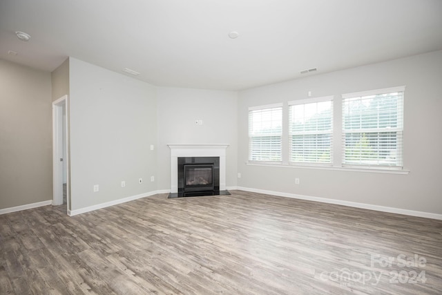 unfurnished living room featuring dark wood-type flooring