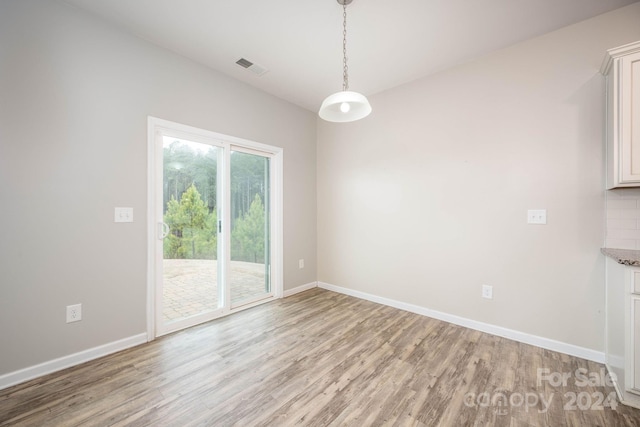 unfurnished room with light hardwood / wood-style flooring