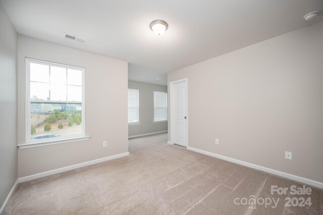 unfurnished room with light colored carpet