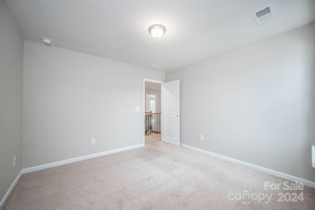 spare room with light colored carpet