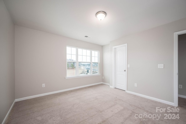 empty room featuring light carpet