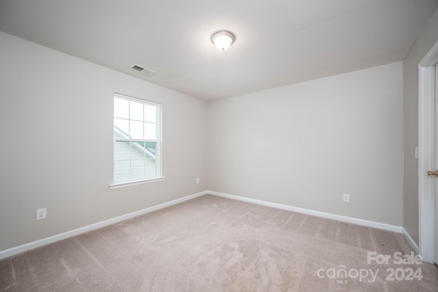 spare room with light carpet