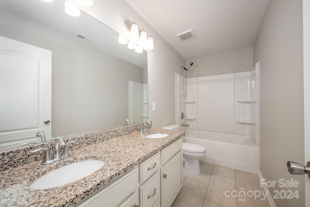 full bathroom with tile flooring, toilet, washtub / shower combination, and dual bowl vanity