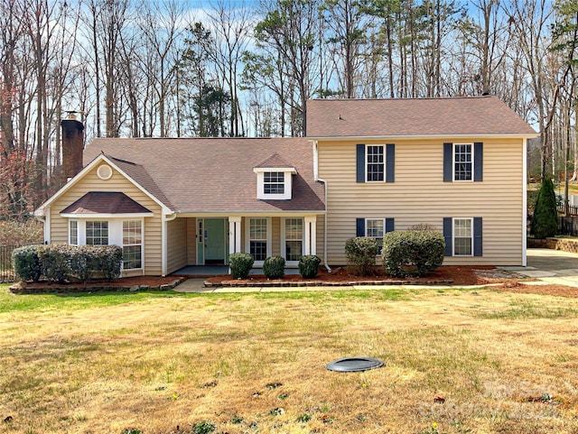 view of front of home with a porch and a front yard