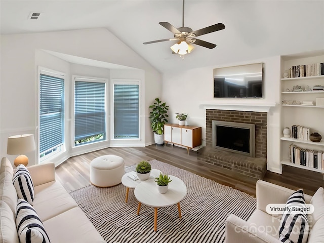 7210 Morningdew Ct, Denver, NC 28037 - living area with wood finished floors, ceiling fan, lofted ceiling, a fireplace, and built in features
