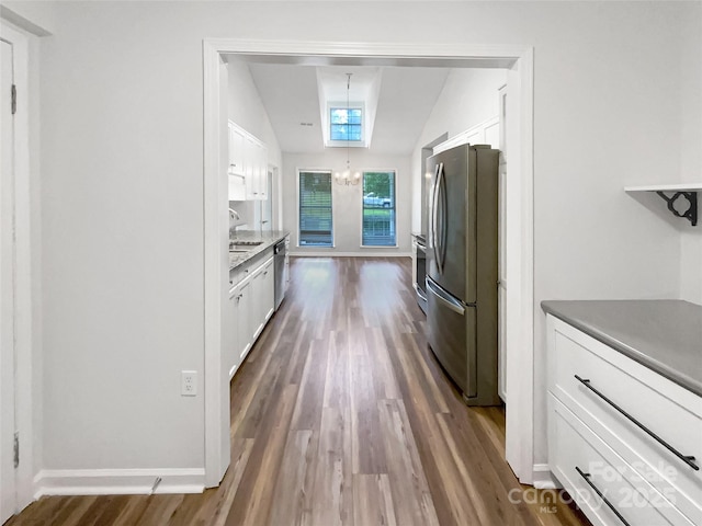 7210 Morningdew Ct, Denver, NC 28037 - kitchen featuring appliances with stainless steel finishes, lofted ceiling, white cabinets, dark wood finished floors, and a sink