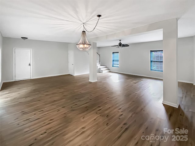 7210 Morningdew Ct, Denver, NC 28037 - unfurnished living room with dark wood-style flooring, a chandelier, and baseboards