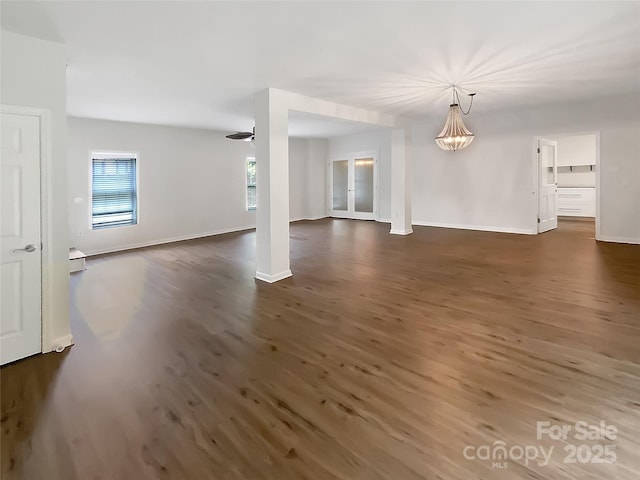 7210 Morningdew Ct, Denver, NC 28037 - unfurnished living room with dark wood-style flooring, a chandelier, and baseboards