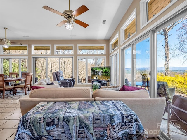 tiled bedroom featuring ceiling fan