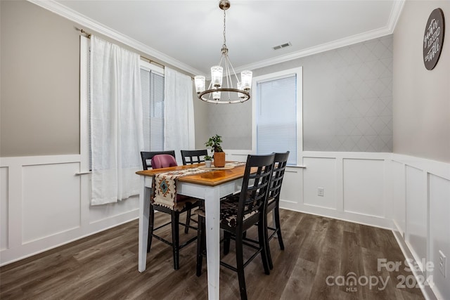 dining area with crown molding, a notable chandelier, and dark wood-type flooring