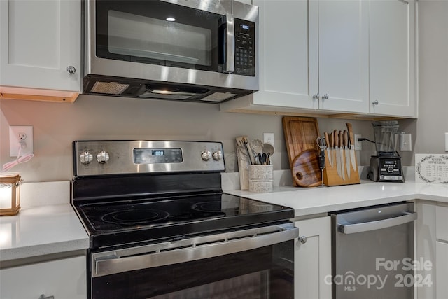 kitchen with white cabinetry and appliances with stainless steel finishes