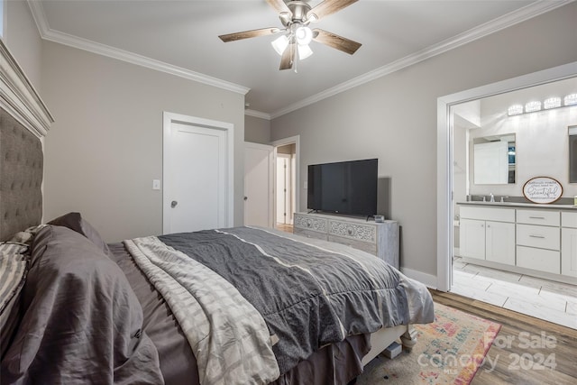 bedroom featuring ceiling fan, light hardwood / wood-style floors, sink, ensuite bath, and ornamental molding