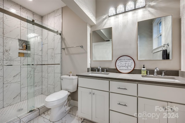 bathroom featuring a shower with shower door, toilet, double sink vanity, and tile flooring