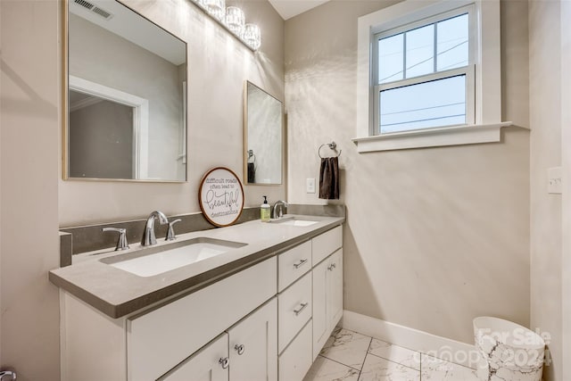 bathroom with double sink, tile floors, oversized vanity, and toilet