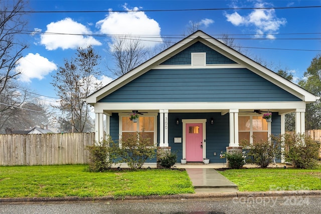 view of front of home featuring covered porch and a front lawn