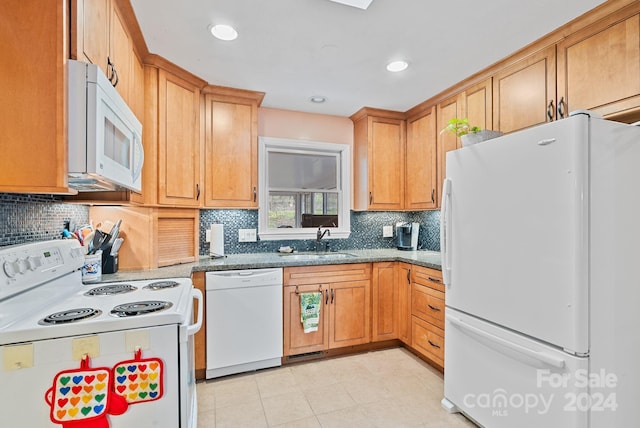 kitchen featuring backsplash, white appliances, sink, and light tile floors