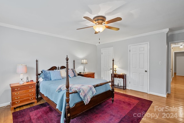 bedroom featuring ceiling fan, crown molding, and hardwood / wood-style flooring