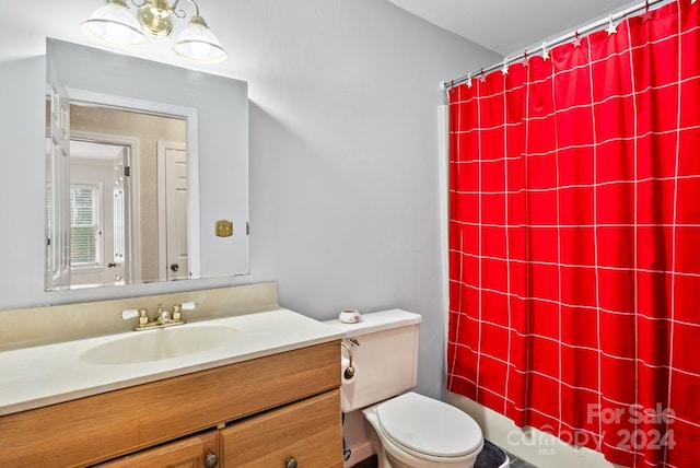 full bathroom with shower / tub combo with curtain, vanity, and toilet