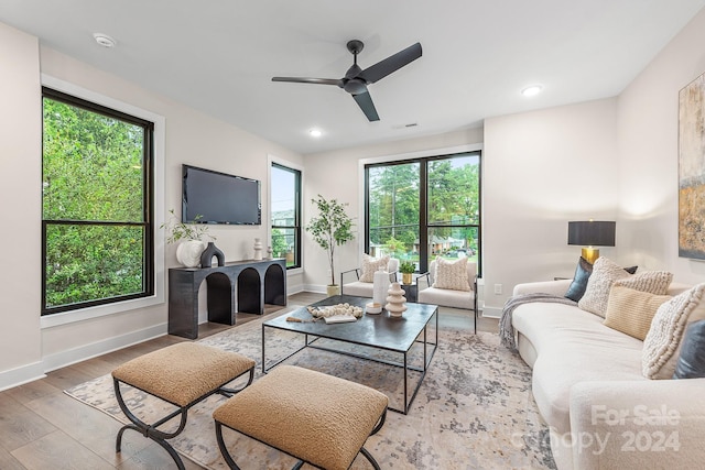 living room featuring ceiling fan and light wood-type flooring