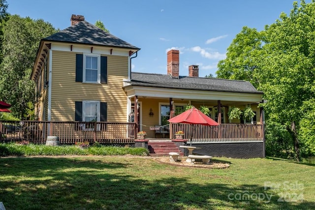 rear view of property featuring a yard