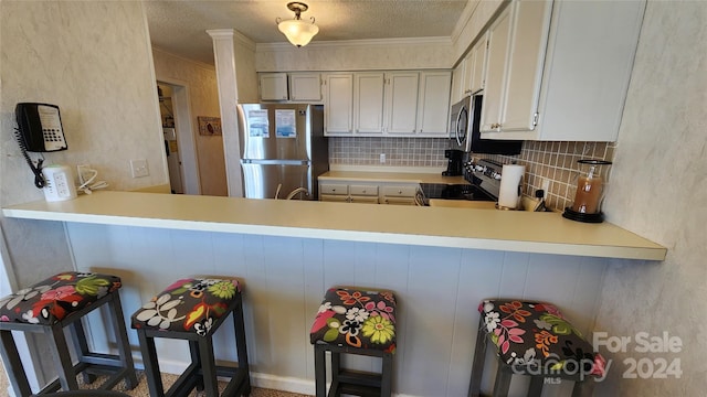 kitchen featuring electric stove, kitchen peninsula, crown molding, stainless steel fridge, and backsplash