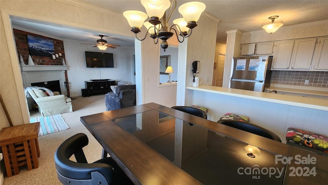 carpeted dining space featuring crown molding and ceiling fan with notable chandelier