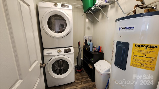 laundry area featuring dark wood-type flooring, water heater, and stacked washer and dryer