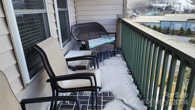 view of snow covered back of property