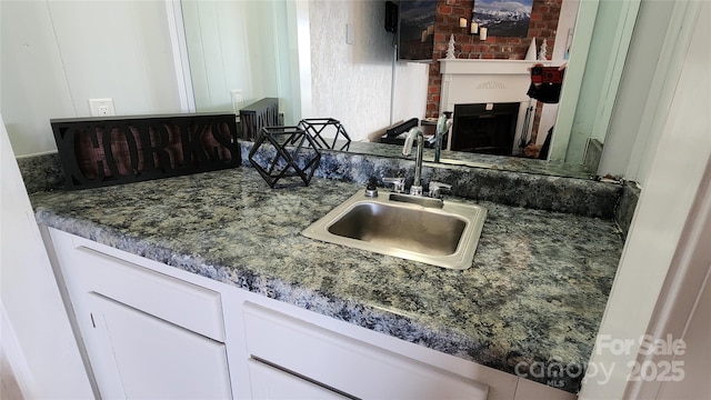 301 Pinnacle Inn Rd Unit 2306, Beech Mountain, NC 28604 - kitchen featuring dark stone counters, a sink, white cabinets, and a fireplace