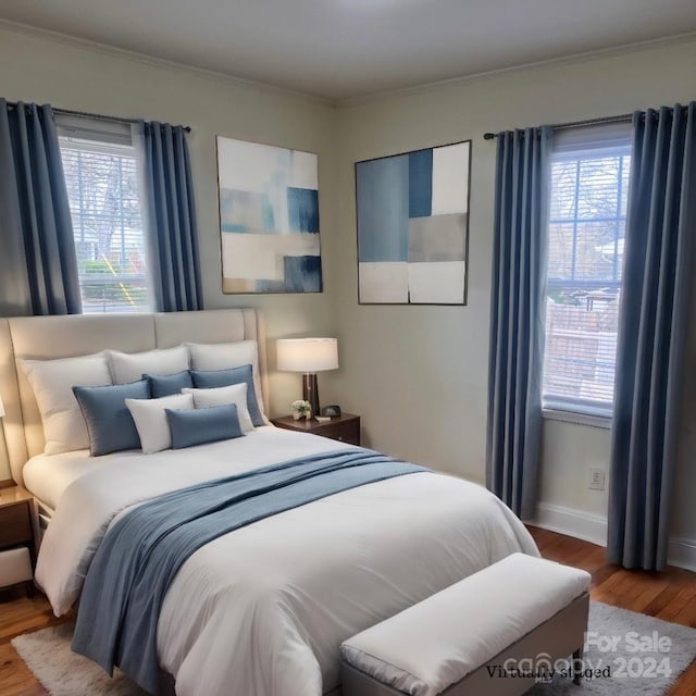 bedroom featuring ornamental molding and wood-type flooring