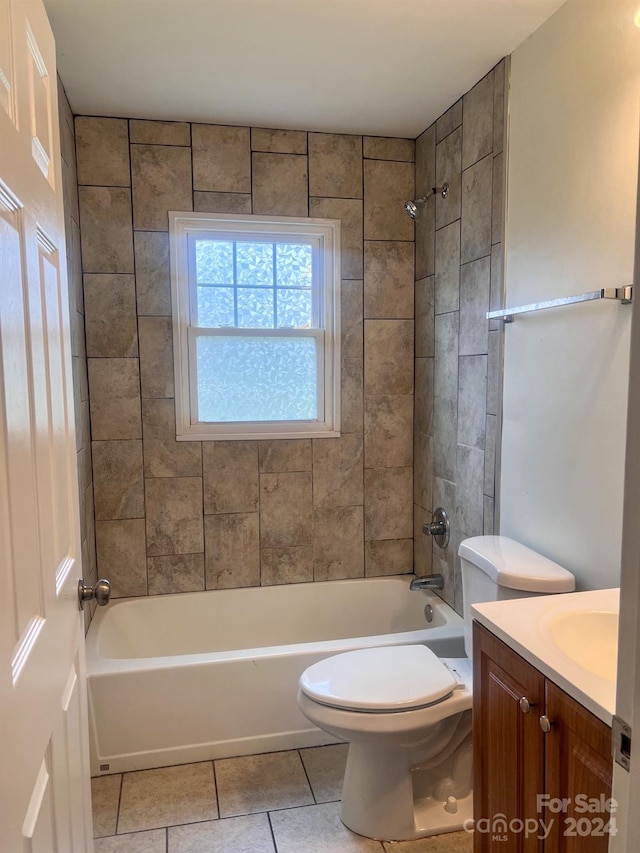 full bathroom with toilet, tile flooring, tiled shower / bath combo, and vanity