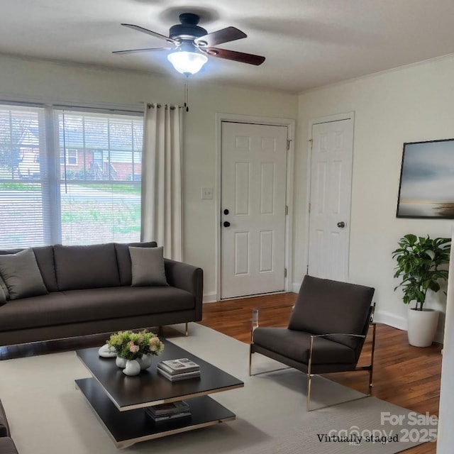 living room featuring dark wood-type flooring and ceiling fan